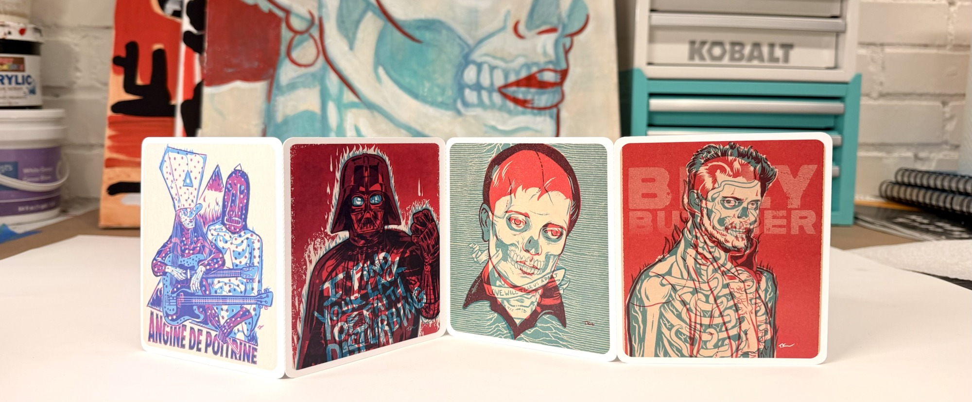 Photo of a physical four-panel Hard Send print in Travis Knight's studio, with the original split-face painting visible on canvas behind it